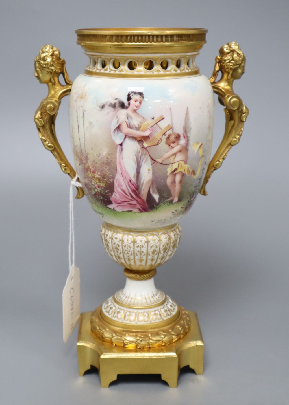A French painted porcelain and gilt metal two-handled vase, signed I Marchand, height 23.5cm (lacking cover),